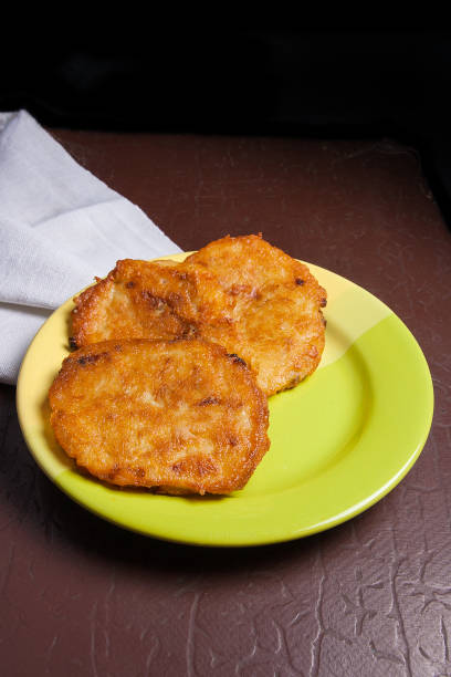 Potato pancakes with meat on green plate