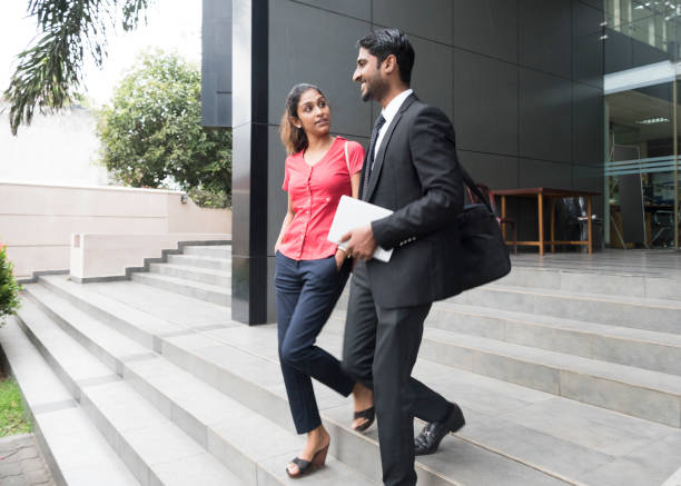 istock Young woman and businessman with tablet on steps 660153854
