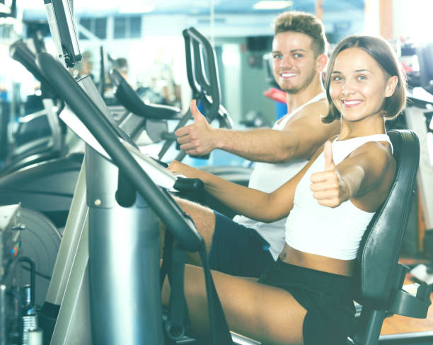 istock Man and woman workout using cycling cardio machines 660158110