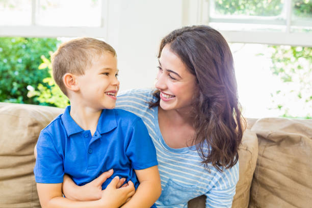 istock Mother and son having fun in living room 660161276