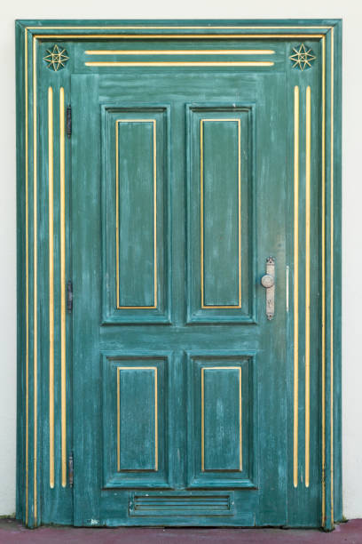 istock Green door with golden ornament 660162610