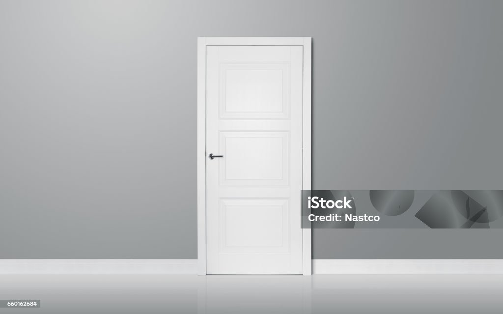 The door Close up of closed wooden door in the empty room with copy space Door Stock Photo