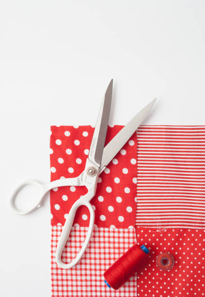 istock Sartorial scissors, pieces of colored fabric on a white background 660164100