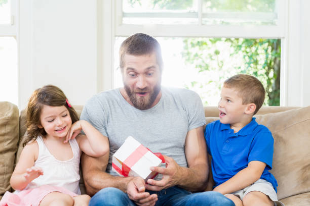 istock Father receiving a gift from his kids 660170400