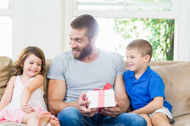 istock Father receiving a gift from his kids 660170808
