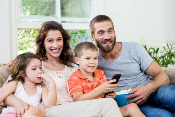 istock Family having fun while watching television 660181312