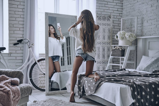 snapping selfie at home. - woman in mirror backview imagens e fotografias de stock
