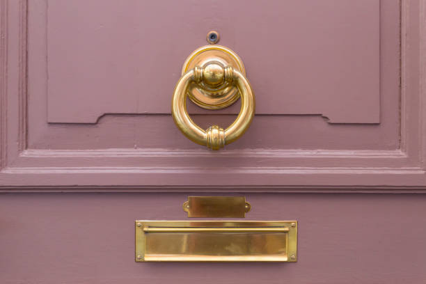istock Pink wooden door with golden ring and mail box 660182364