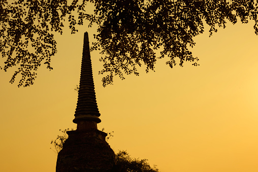 Ayutthaya, Thailand - March, 12, 2017 : Silhouette of Ancient ruins and pagoda of Wat Phra Si Sanphet old temple famous attractions during sunset at Ayutthaya Historical Park, Thailand.