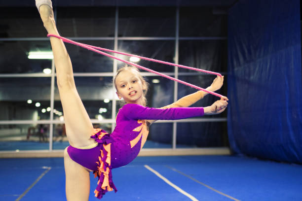 Girl is engaged in rhythmic gymnastics