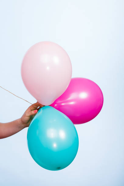 istock Female hand holding colorful balloons. 660208172