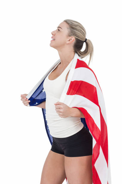 Female athlete with american flag on her shoulders