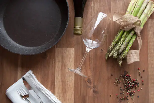 Decoration with pan for asparagus eating on a rustic wooden table