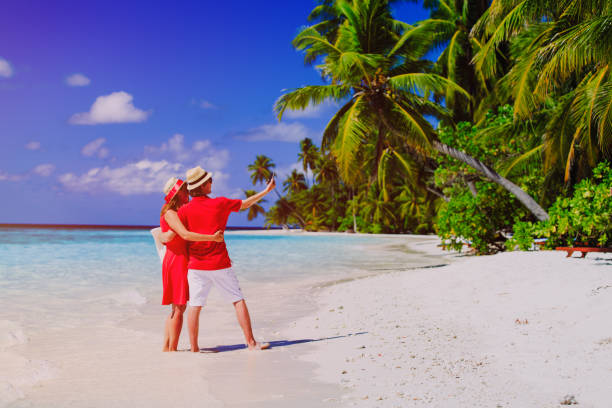 istock Young happy couple making a selfie on beach 660221460