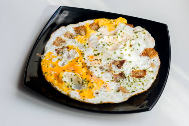 istock fried eggs with toasts and chopped  parsley 660221878