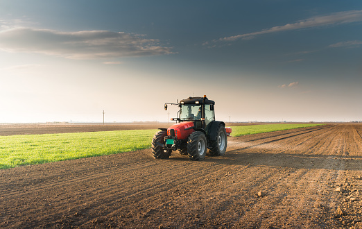 Tractor difusión de fertilizantes artificiales en el campo photo