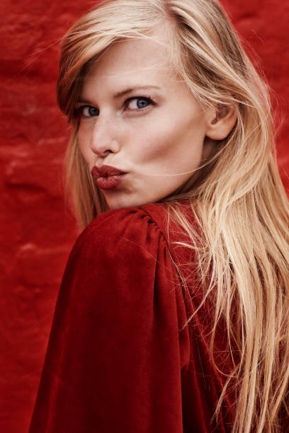 Red lipstick kisses Beautiful blond with red lipstick blowing kiss puckering stock pictures, royalty-free photos & images