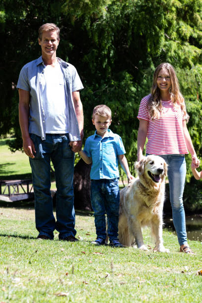 istock Happy family standing in the park 660247376