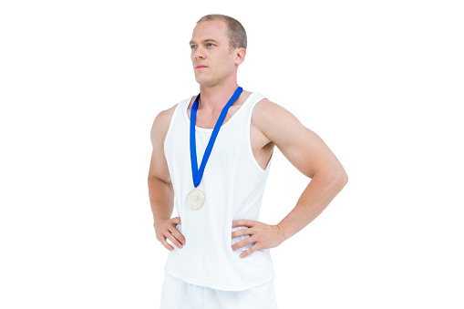 Close-up of athlete with medal on white background