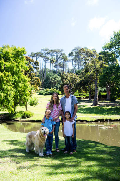 istock Happy family standing in the park 660248810