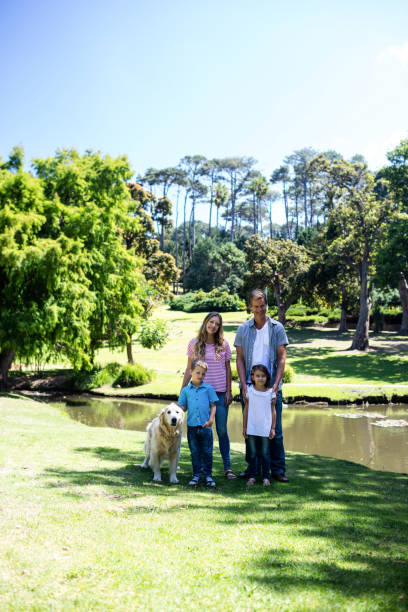istock Happy family standing in the park 660249268