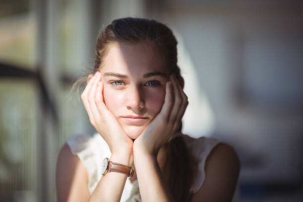 istock Pretty schoolgirl sitting in classroom 660249896