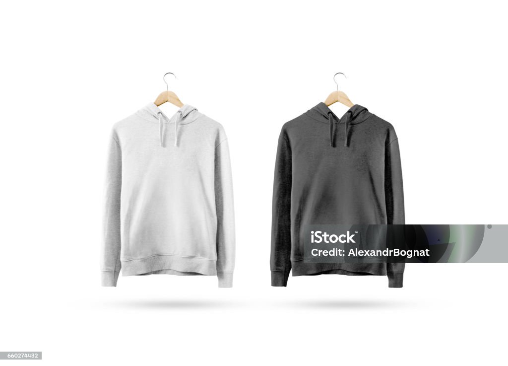 Blank black and white sweatshirt mockup hanging on wooden hanger Blank black and white sweatshirt mockup hanging on wooden hanger. Empty sweat shirt mock up on rack isolated. Clear cotton hoody template. Plain textile hoodie design. Loose overall casual jumper. Coathanger Stock Photo