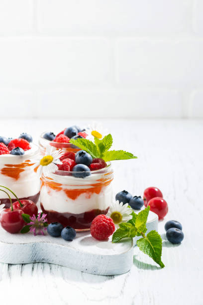istock sweet dessert with jam, cream and fresh fruit, white background 660274892