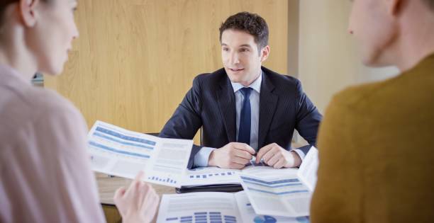 istock Banker discussing with couple 660286742