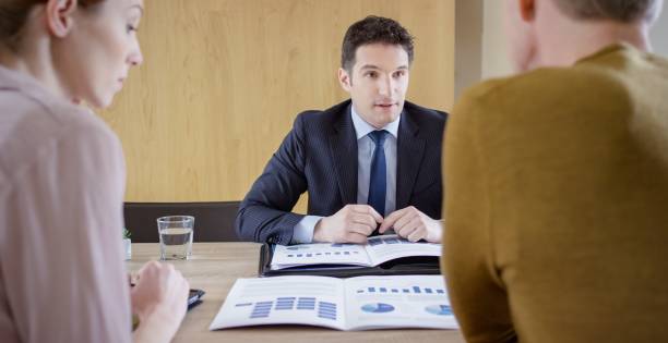istock Banker discussing with couple 660286744