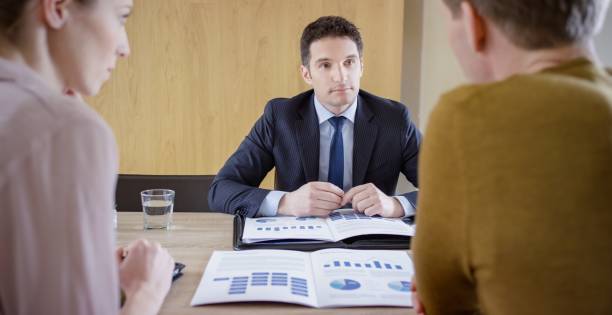 istock Banker discussing with couple 660286766