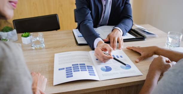 istock Banker discussing with couple 660286846