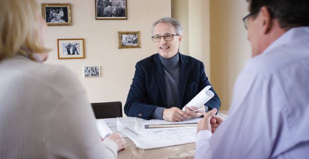 istock Senior couple discussing with architect 660286976