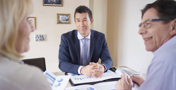 istock Banker visiting senior couple 660287018