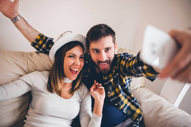 Capturing bright moments Happy smiling young couple taking selfie trophy wife stock pictures, royalty-free photos & images