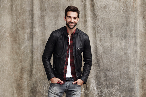 Jeans and jacket guy in studio, smiling