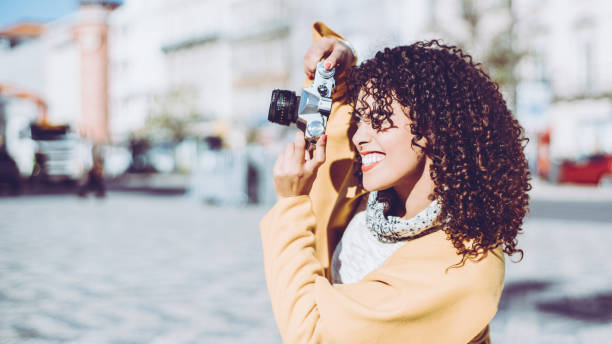 istock Curly beautiful woman with retro photo camera 660303304
