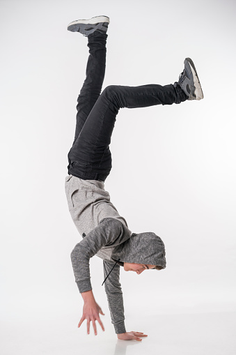 Male Handsome Teenager and hiphop dancer jumping on White Background