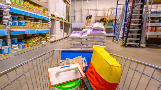 Shopping cart in DIY shop Shopping cart in Hardware store with brandless cement, tools and other goods to lay concrete floor construction material stock pictures, royalty-free photos & images