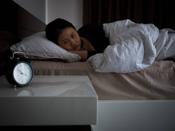 istock woman lying on bed awaking, insomnia concept 660308998