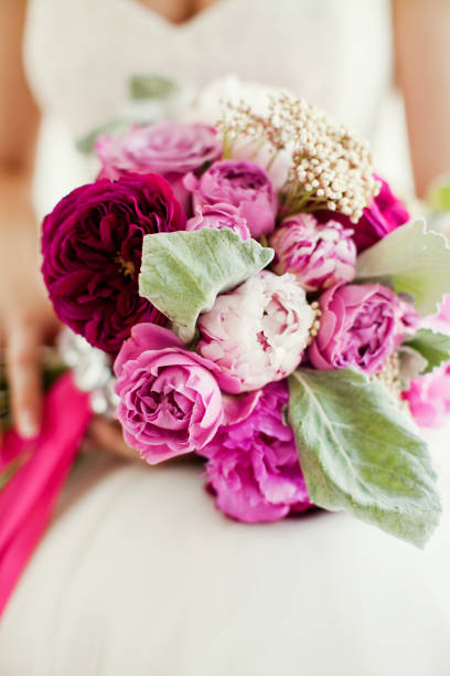 istock Beautiful pink bouquet in bride's hands 660311484