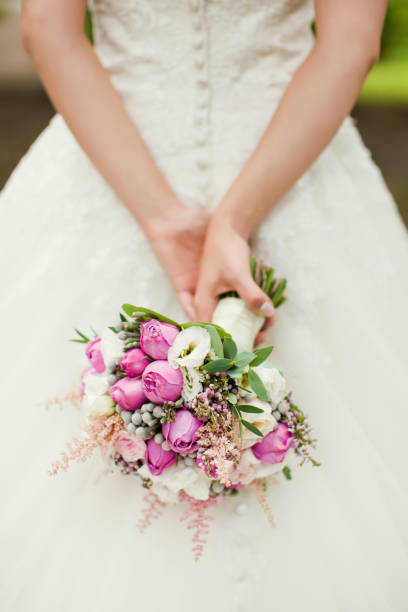 istock Beautiful pink bouquet in bride's hands 660311582