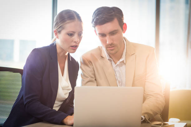 istock Businessman and businesswoman interacting using laptop 660311854