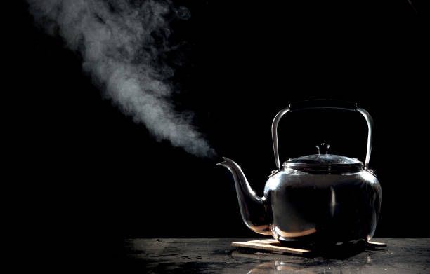 istock Tea kettle with boiling water on a black background 660315812