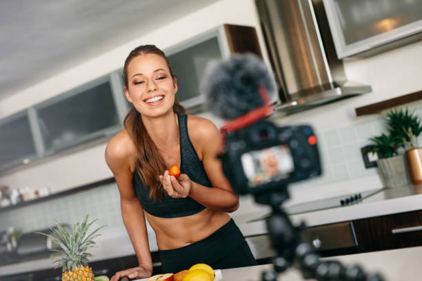 istock Young woman recording content for her blog in kitchen. 660316080