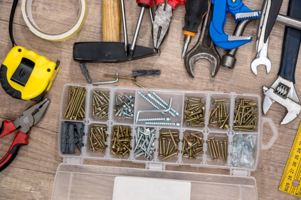 istock set of tools and instruments, screw on wooden background. 660318772