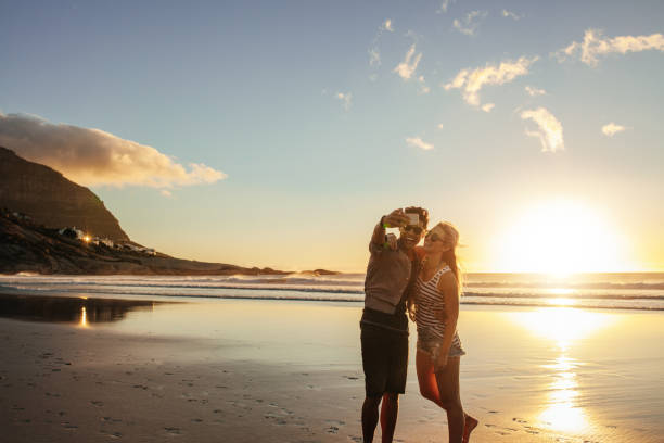istock Happy young couple taking self portrait at beach 660319024