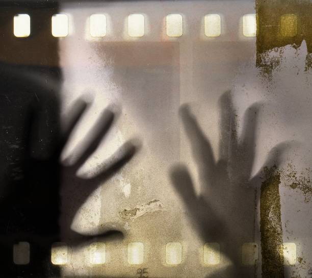istock Two hands on vintage film strip frame. 660321898