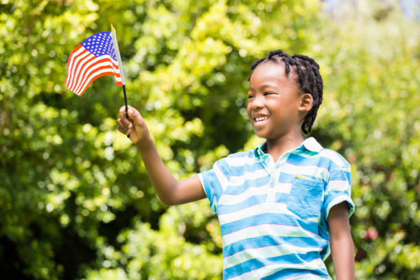 istock Smiling boy waving american flag 660322060