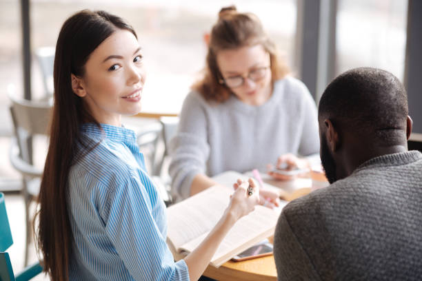 istock Happy female student studying with her fellows 660322316